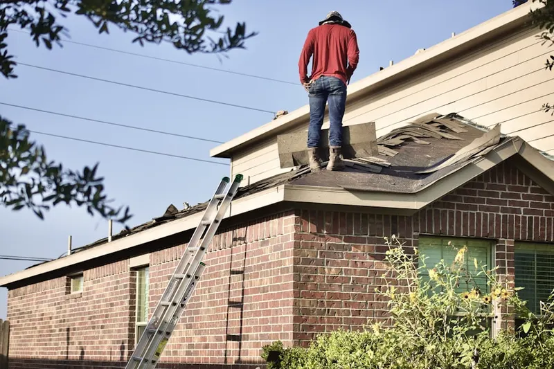 Professional roofer working on a residential roof in Brickell Residential District